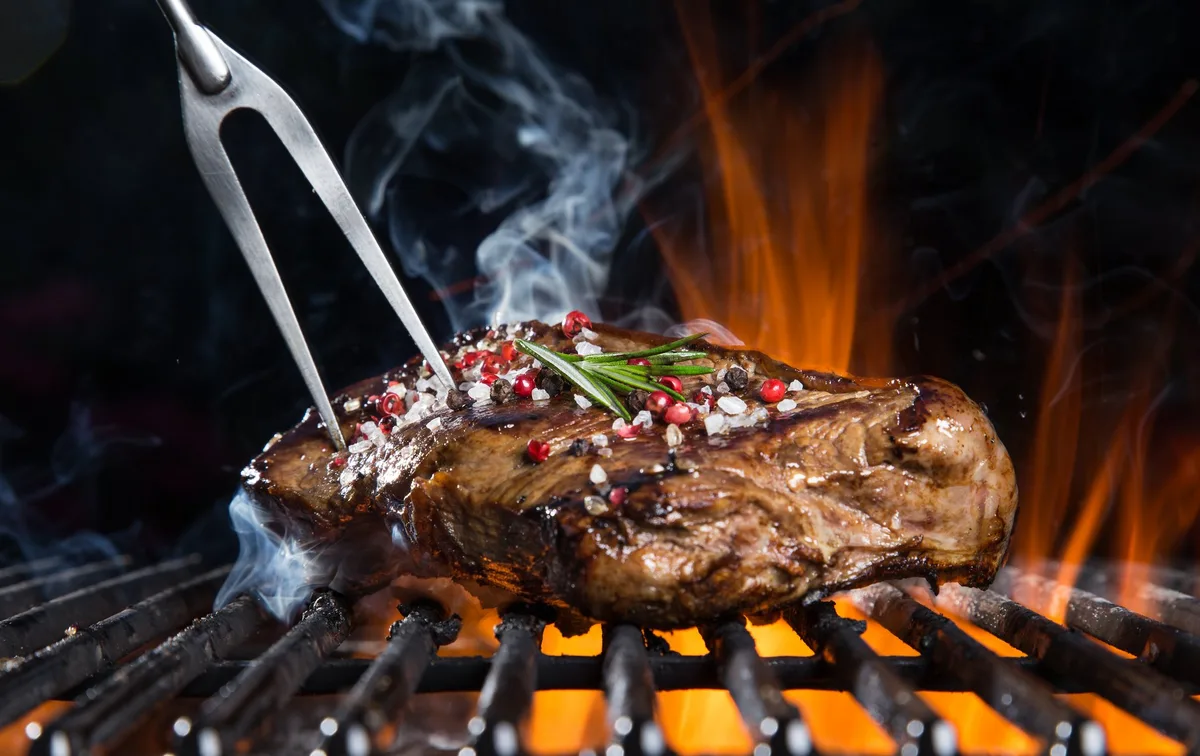 AdobeStock_100392644 Beef steak on the grill.