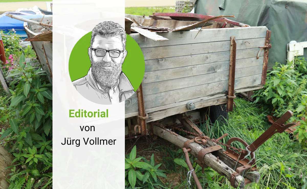Editorial-Vollmer-Juerg Ein alter Wagen ist gefüllt mit Sperrgut. im Vordergrund ist das gezeichnete Porträt von Jürg Vollmer zu sehen.