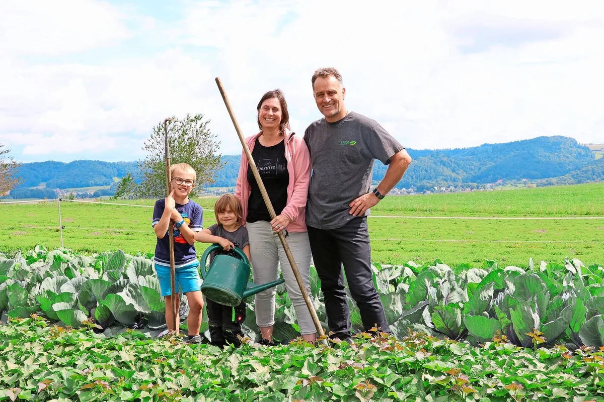 ce7526d7f53a24381cf9f0623de79bbc5de73cc1aca92bfd0cb47c373476293e Daniel und Flavia Steiner mit Livio und Elina: Hier wächst das Gemüse für den Direktverkauf und im Hintergrund der Zitronenthymian.