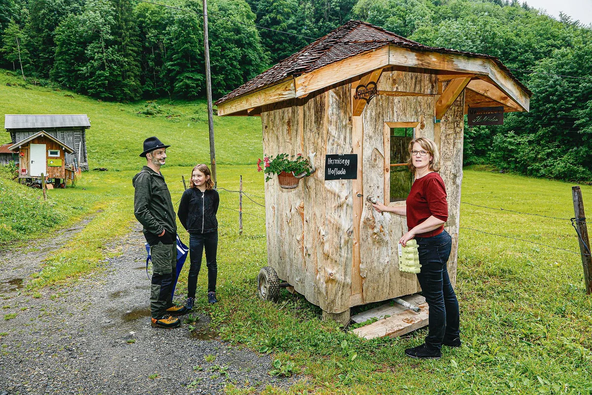 806d7f2bf5fc619d545fe8fbf32d63fe02e01315 Oskar, Svenja und Antonia Bissig bei ihrem Hofladenhüttli, das günstig neben einem Wanderweg gelegen ist. (Bild Erika Rebsamen)