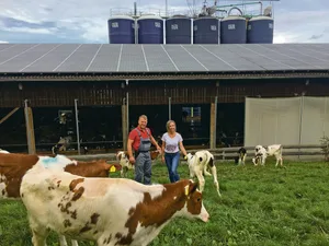 Christine und Thomas Gerber in der Kälberweide vor dem 2009 erbauten Milchviehstall mit Platz für 100 laktierende Kühe. Die 100 000er-Kühe habe er auch dem Stall zu verdanken.(Bild Armin Emmenegger)