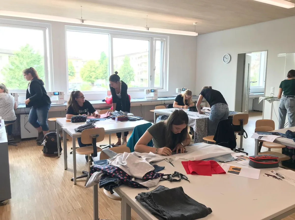 be48a3abea5ec3ebff2ce73fd9514f9b7412db46 Die Schülerinnen wurden in drei Gruppen aufgeteilt. Jede Lehrerin führt ein Atelier. Die Schülerinnen nähen aus einer alten Jeans eine Kochschürze, die später in der Hauswirtschaft zum Kochen gebraucht wird. (Bild fj)