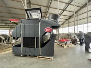 The Lely Sphere separates feces from urine, converting them into three types of fertilizer. The photo shows a cutaway module where the honeycomb structure of the nitrogen filter is visible. In the background: the Lely Discovery Collector, a dung-collecting robot.