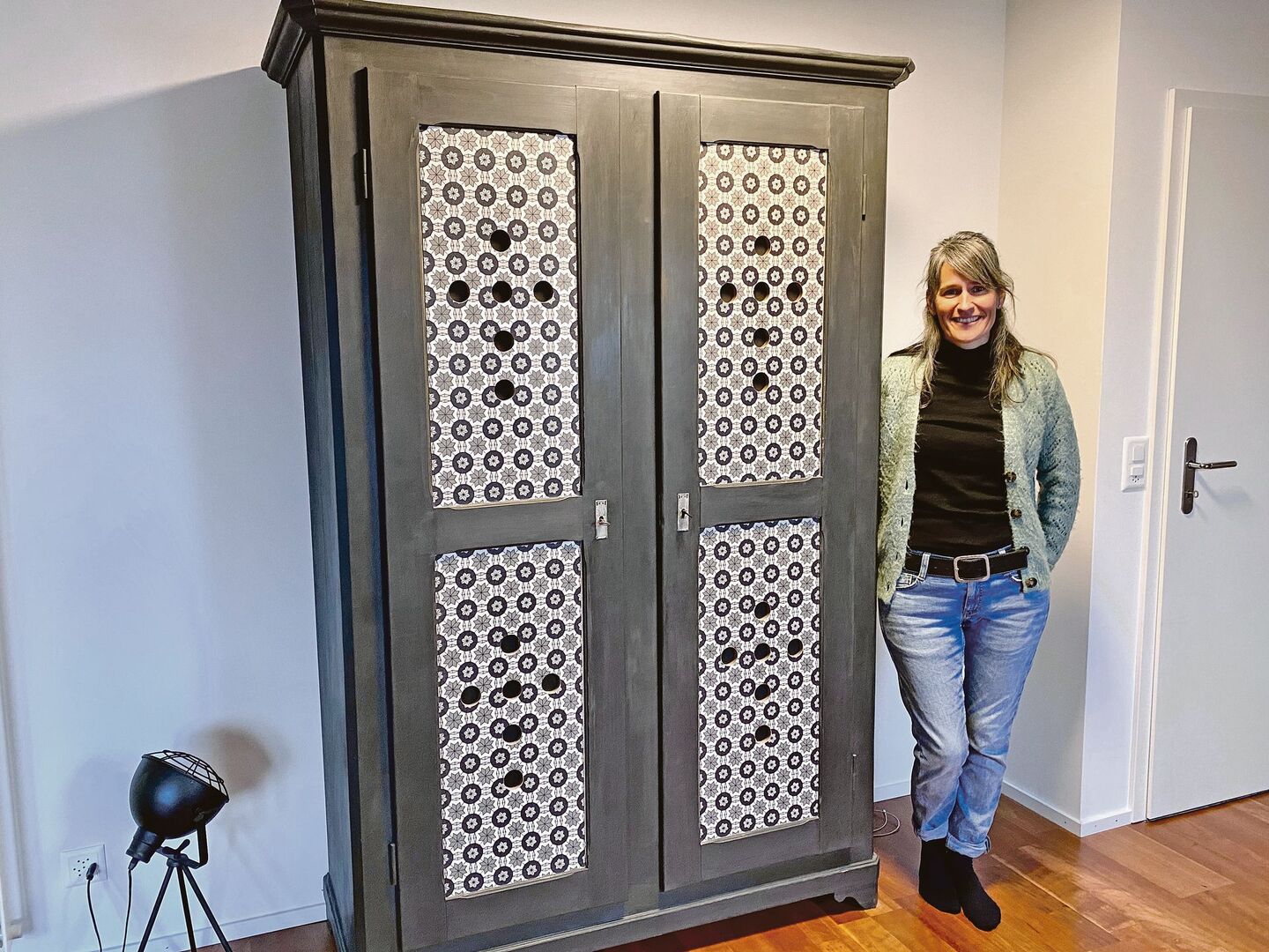 Jasmin Rupp neben einem alten Schrank, dem sie einen neuen Look verpasst hat.