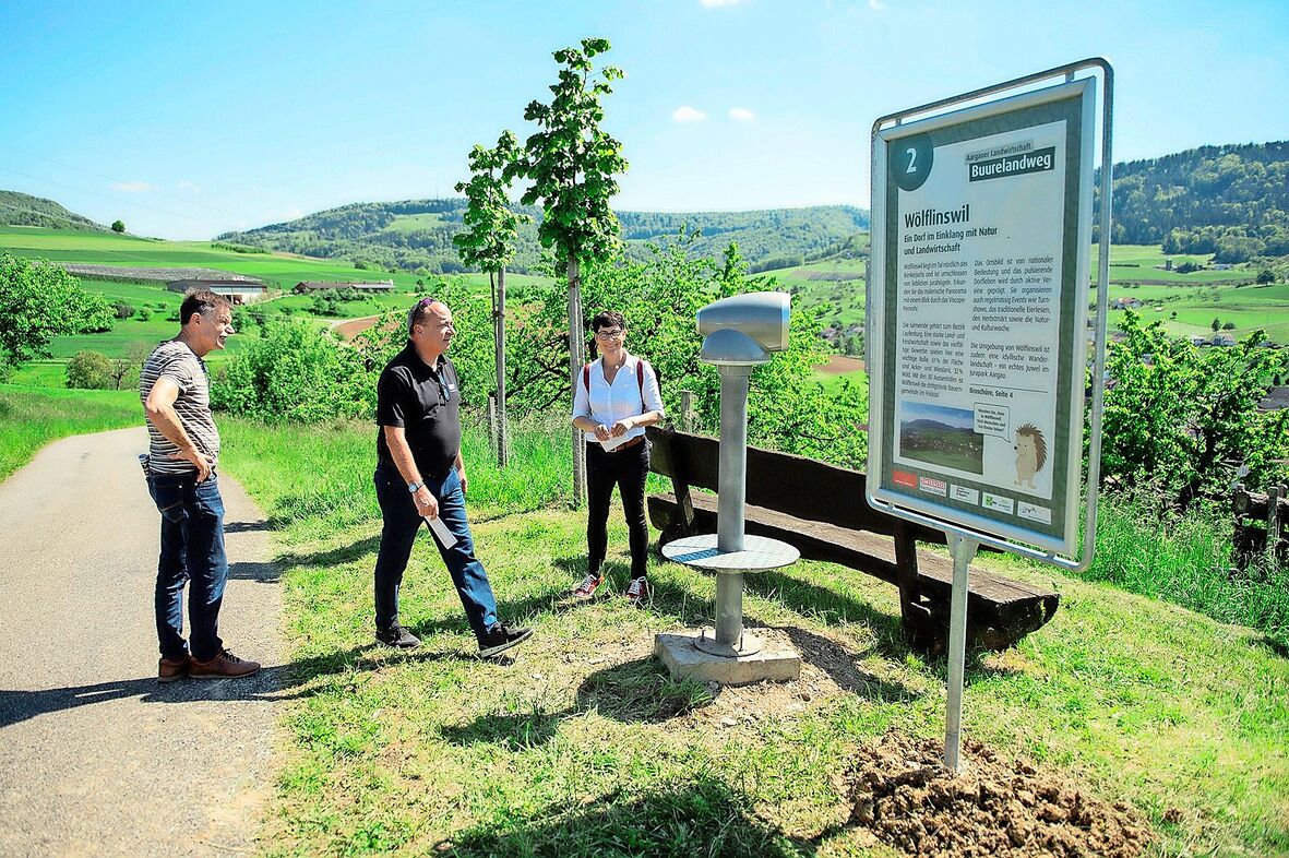 Markus Dieth (Mitte) geht zum Viscope-Teleskop, um den Blick über die Gegend um Wölflinswil schweifen zu lassen. Colette Basler (rechts) führt durch verschiedene Posten des Buurelandwegs.